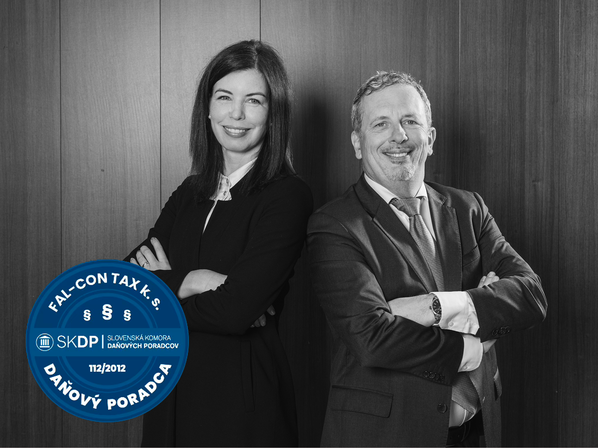 a woman and a man standing back to back wearing suits